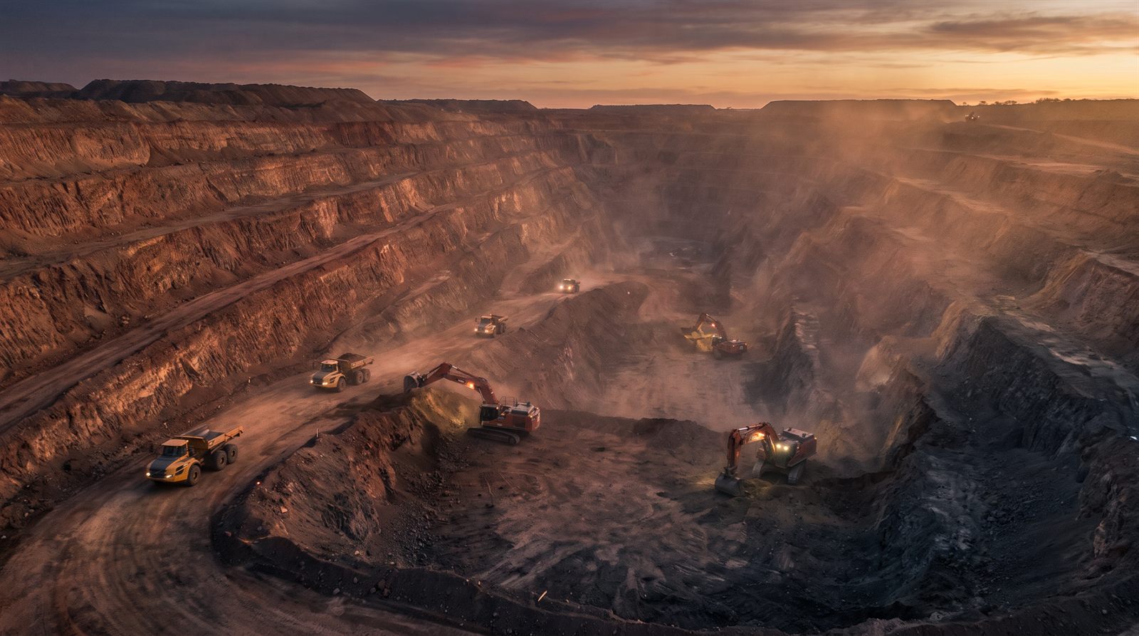 Placeholder photography: terraced excavation with an excavator at dusk.